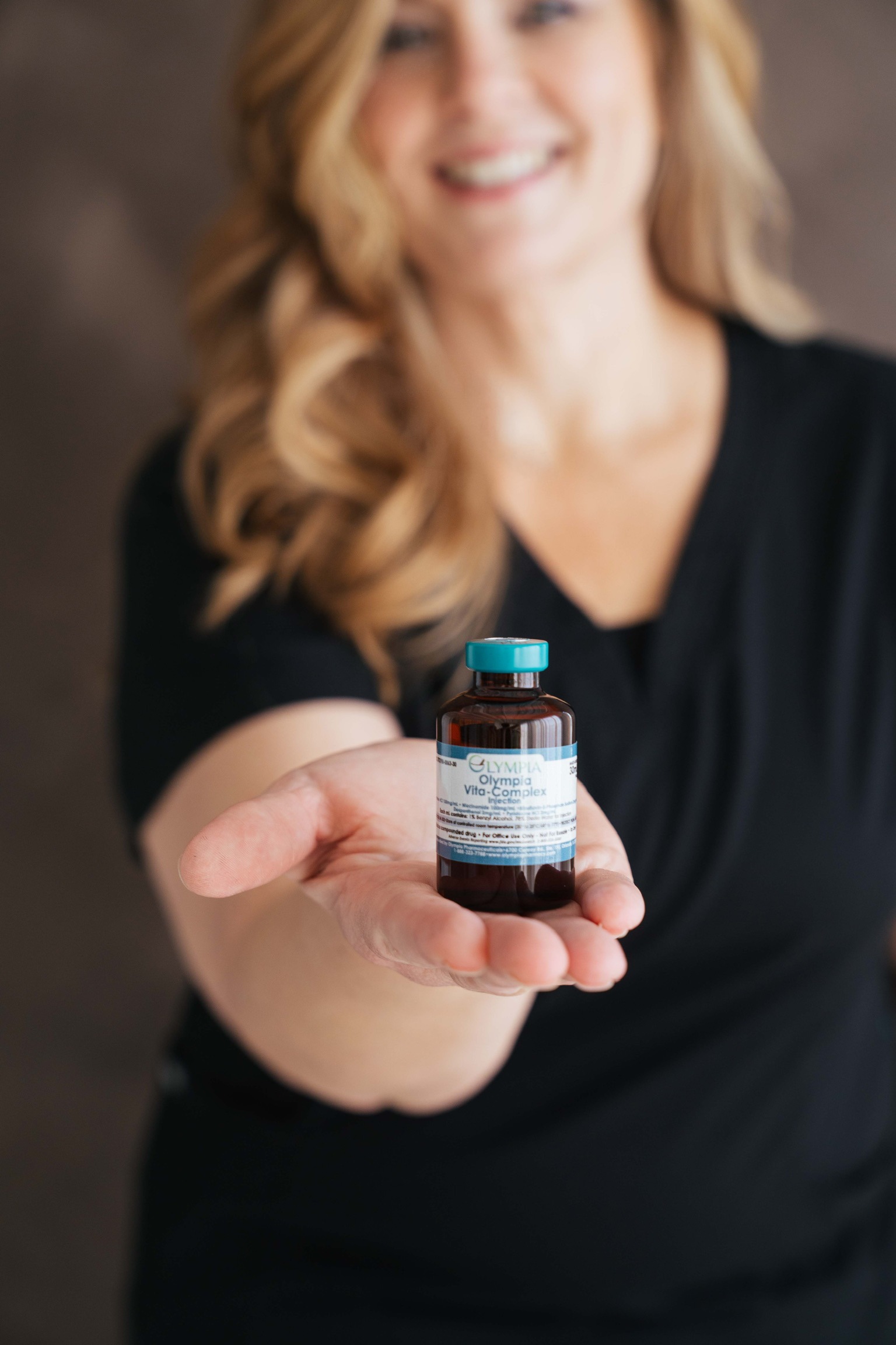 Dena holding medication vial